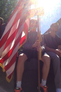 A student holds the American flag during the AHS 9/11 memorial ceremony.