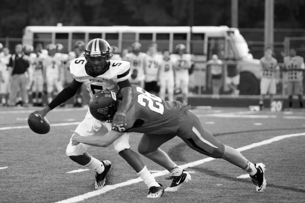 Senior linebacker Eli Mackay tackles the Monticello Mustang quarterback in the backfield during the first Albemarle home game on Aug. 31. 