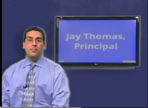 Principal Jay Thomas addresses the student body via the WPAT news channel.