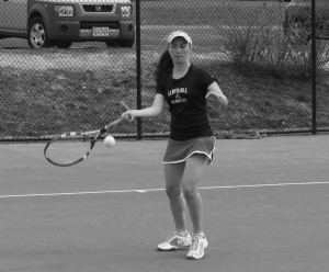 Senior Callie Murray forehands the ball towards her opponent.