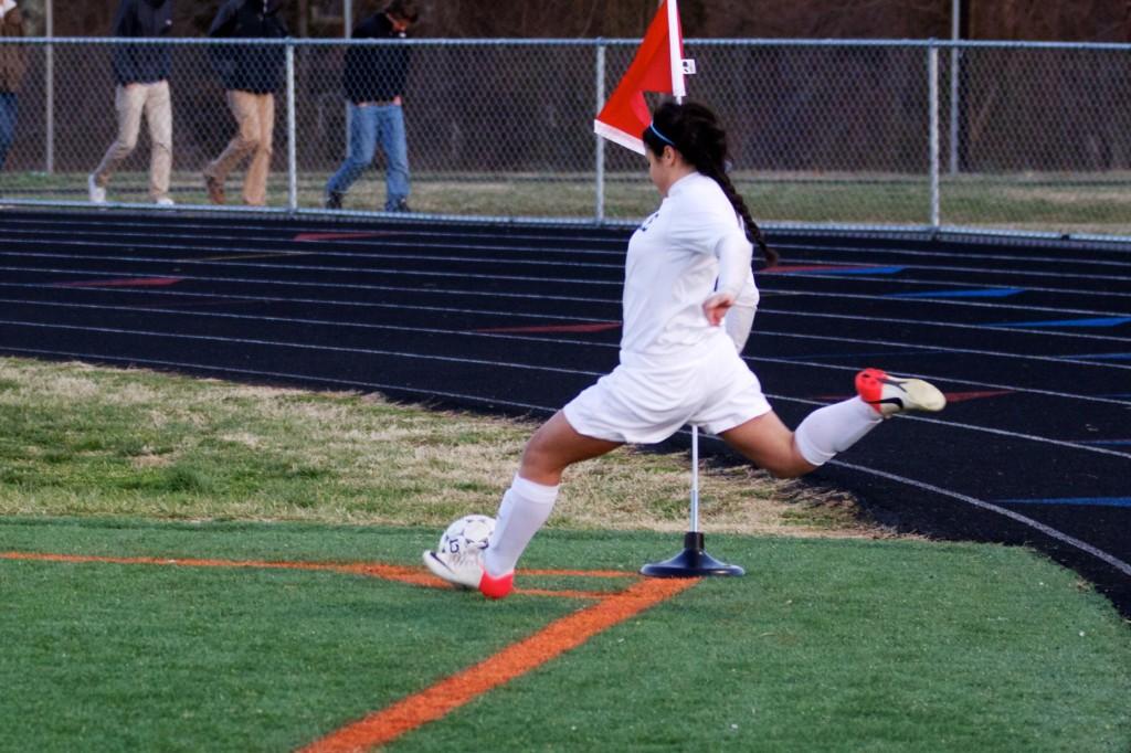 Sophomore Jazzy Loredo drives in a corner kick at a game on March 19 against North Stafford. The team won 3-0 and are now competing in Districts tournaments to make it to Regionals. The girls hope to take the season further than last year. 