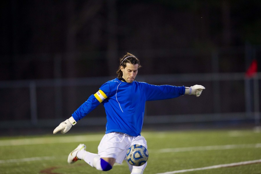 Senior goaltender Matt Natale punts the ball during a home game against Western on April 10. The Patriots lost in a close game of 0-1 against the Warriors.