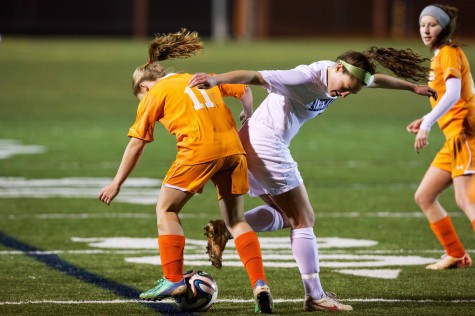 Senior forward Ali Starr is challenged by an opponent during the same game against Orange County. Starr scored 3 of the 8 goals in the team’s win against the Hornets.