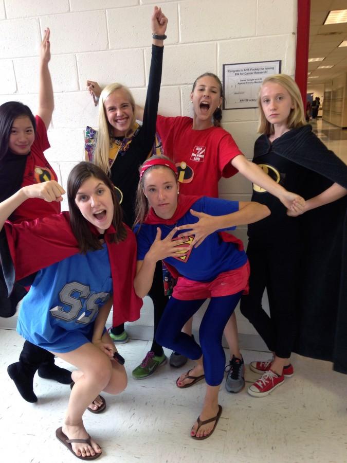 A group of sophomores pose in their superhero costumes for spirit week.
