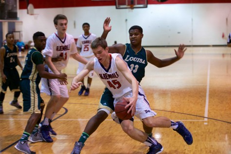 Sophomore Austin Katstra drives to the hoop in last season's game against Louisa. The Patriots dominated the Lions en route to a 82-48 victory.