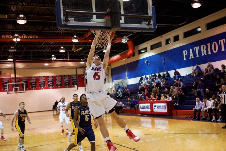 Sophomore Austin Katstra finishes a massive dunk against Fluvanna on Dec. 9. Katstra led the Patriots to a 70-49 victory over the Flucos. Katstra dunks often motivate the crowd and get them more involved in the game.