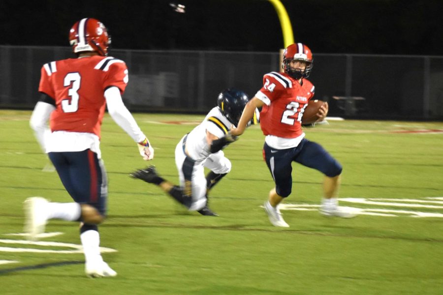 Junior smart safety Nolan Pitsenburger avoids a Fluvanna take-down during the Oct. 19 Homecoming game. The Patriots beat the Fluccos 24-21 after a final-second 27 yard field goal from senior kicker Yousof Algburi. 