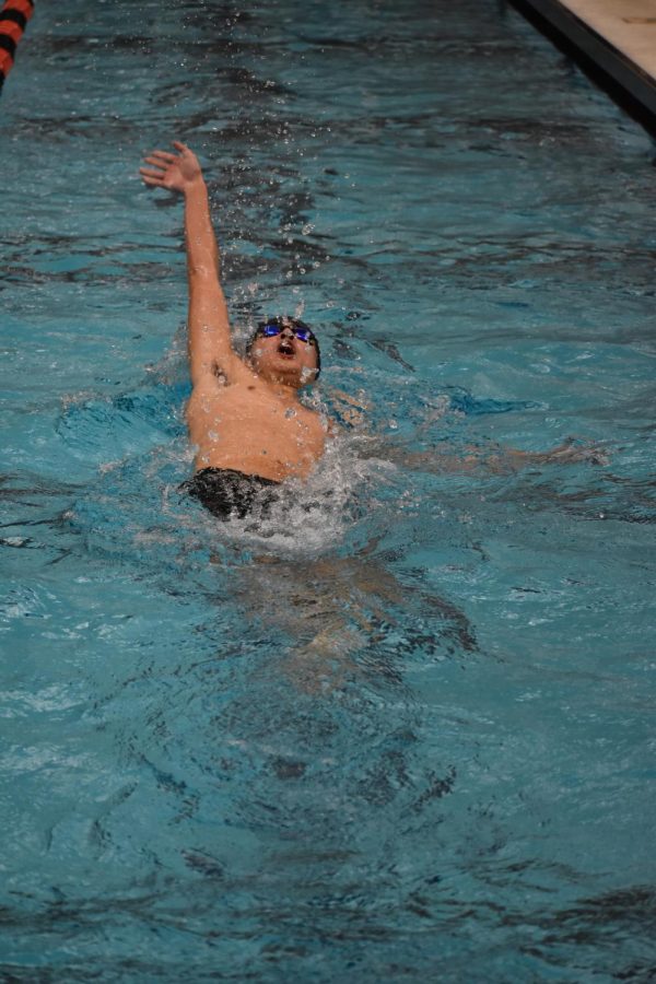 Sophomore David King glides through the pool in the boys 100 backstroke. King finished first in Heat 3 and second overall with a time of 52.63 seconds.