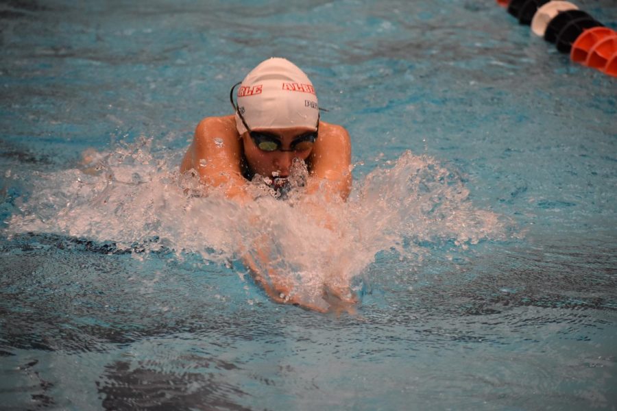 Junior Evelyn Marie Czirjak shoots through the water during the girls 100 breaststroke race. Czirjak finished fourth in Heat 6 and in the top ten overall with a time of 1 minute 12.53 seconds.