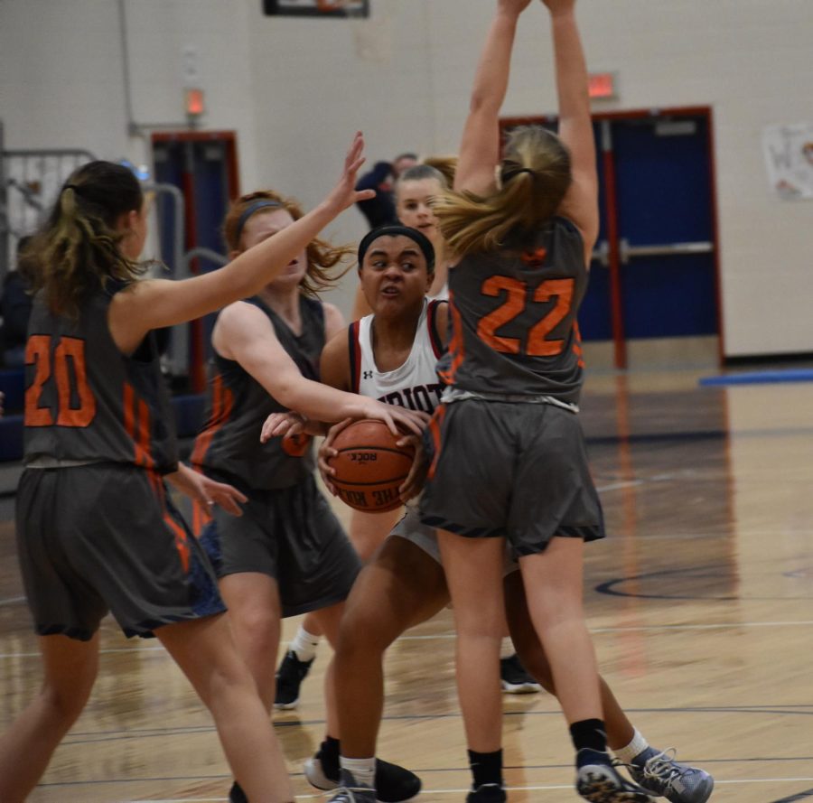 Senior Amaya Pendelton fights through a horde of Orange players to claim a rebounded ball. Pendleton brought 10 points to the game and offered fierce defense. 