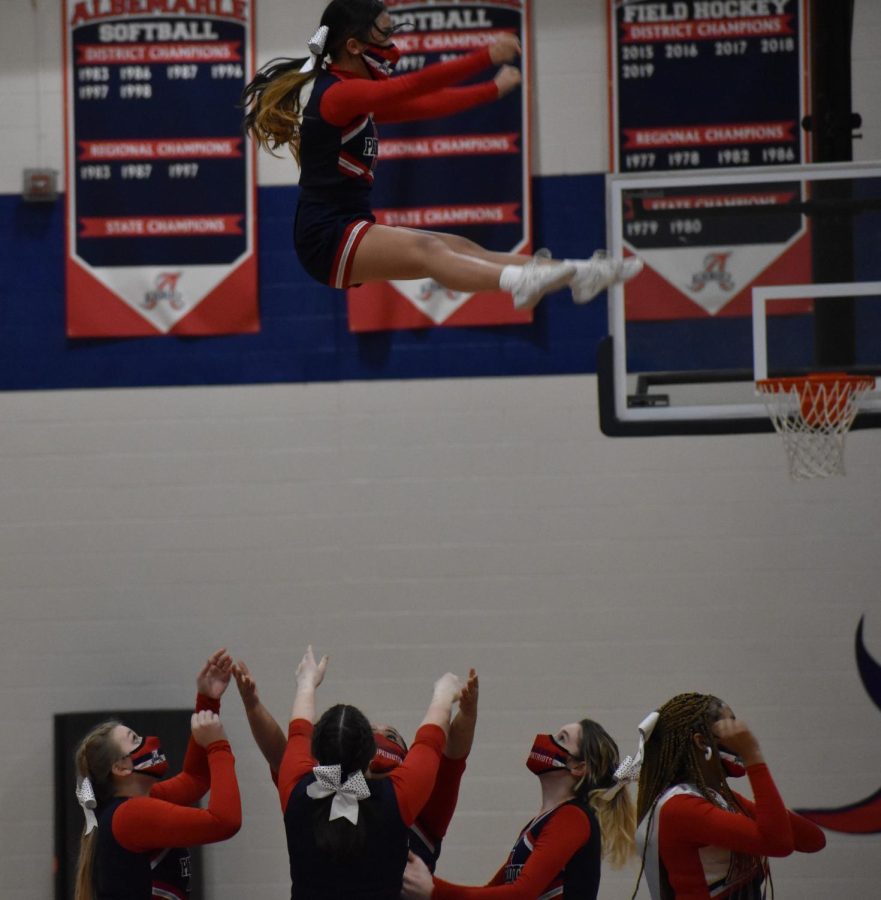 Patriot Cheerleaders perform an acrobatic stunt for the crowd between the first and second quarters.