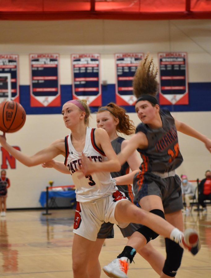 Junior Kaley Maynard receives a pass under the basket before making a layup. Maynard led the scoring with 16 points in the game.