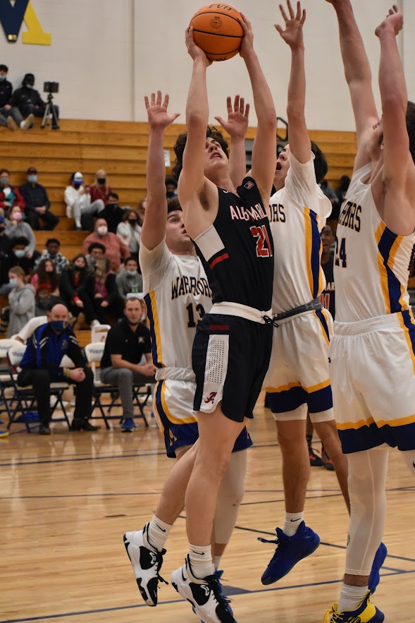 Senior Jason Breen powers through a horde of Western players to get a layup in the last quarter of the game.