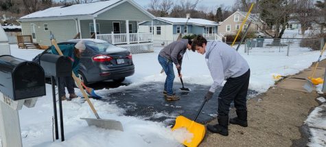 Snow crew members work to clear the sidewalk and driveway of a Belmont resident after the Jan. 17 snow. 