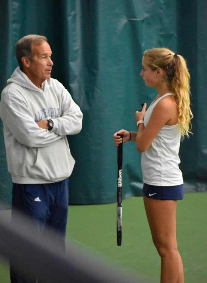 Freshman Macy Moody debriefs with assistant coach Don Paitrick after her win against Riverbends sixth seed player.