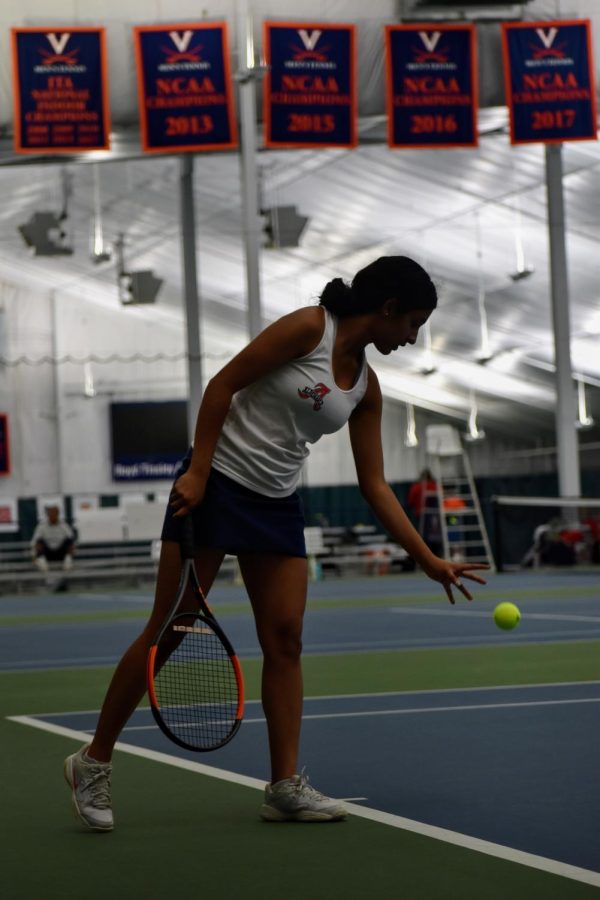 Senior Tess Eluvathingal Muttikkal prepares for her tough matchup against Riverbends first seed player. Despite putting up a fight, Tess lost her match 2-0.
