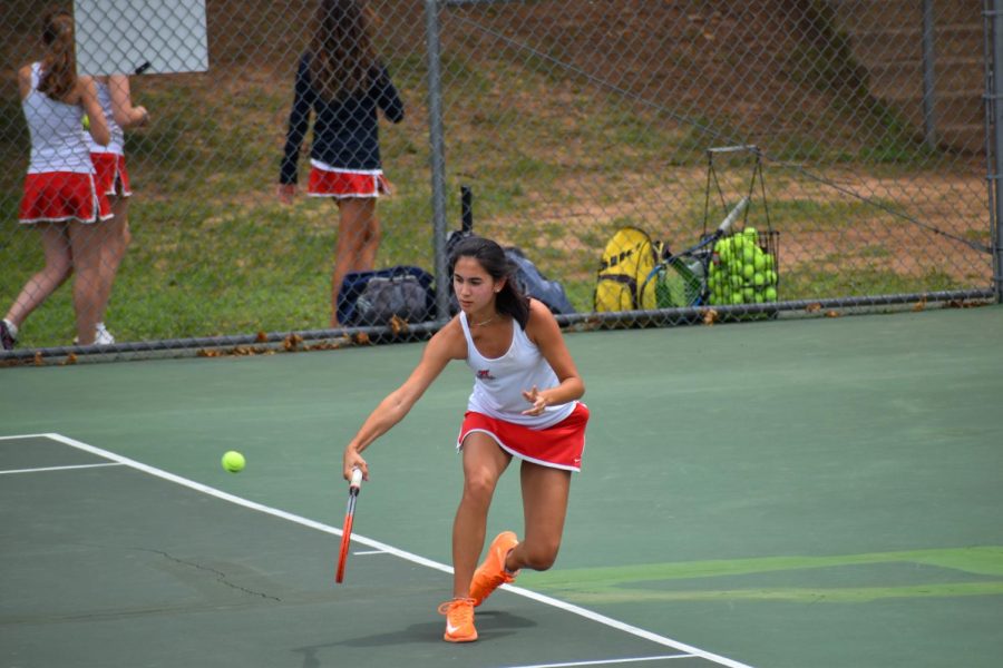 Senior Mia Shen lunges to meet the ball with her back hand during her match against Deep Runs first seed. 