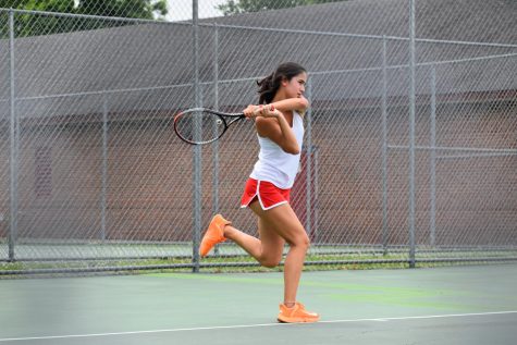 Senior Mia Shen puts all her might into slamming the tennis ball onto her opponents side of the court. 