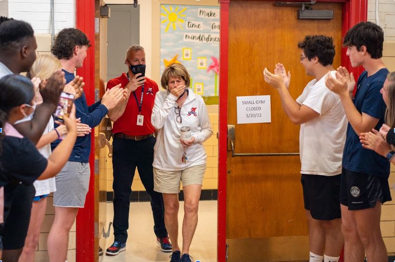 Tyson is shocked when she walks into the small gym for her surprise signing celebration. Athletes formed a tunnel for her to walk through as the drum line beat by the bleachers. 