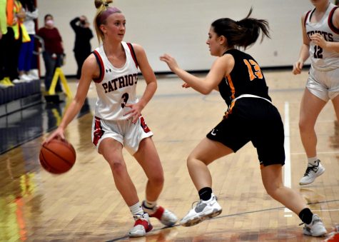 Senior guard Kayley Maynard looks for an opening to get around a determined CHS player. 