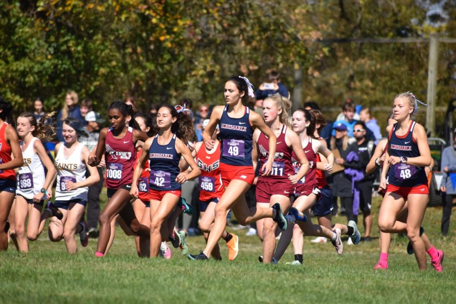 (Left to right) Senior Jenna Coleman, junior Maddie Gypson and senior Hanna Guyton lead the girls varsity pack at the Oct. 8 Albemarle Invitational. They placed 33rd, 10th and 41st, respectively, with the team placing second overall.