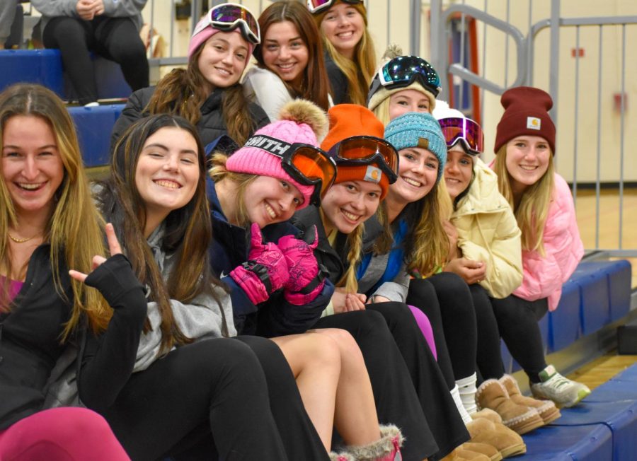 Patriot fans smile, decked out in winter gear for the theme: skiers vs. snowboarders.