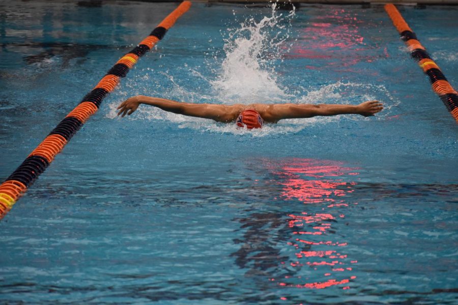 Freshman Bradley Sawyer kicks toward the finish line during the boys 100 butterfly at the Jan. 10 Ben Hair Meet. Both he and junior Alexis Alms (in girls 100 fly) won their heats.