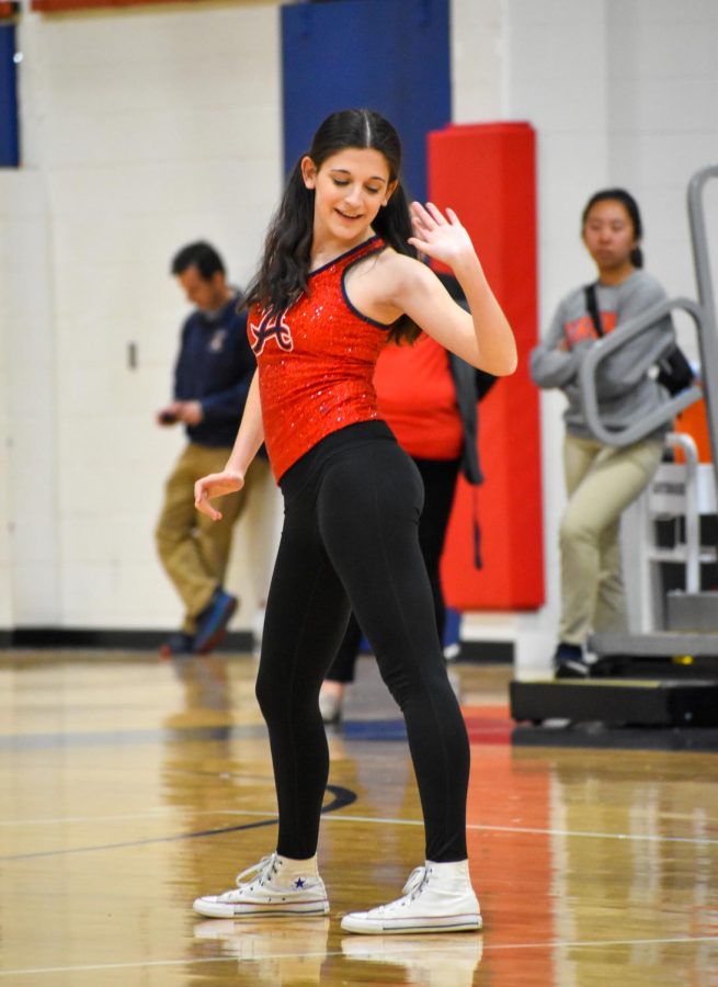 Popping her hip to Maneater by Nelly Furtado, Senior Anya Rothman performs in the Dance Team half-time show during the girls basketball home game against MHS.