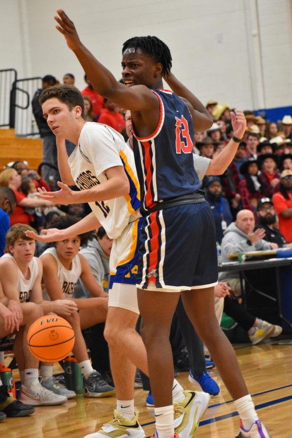 Junior Benny Koutone (right) and Junior Wes Gobble (left) look to the referee for a call as AHS presses full-court defense on the Warriors in the second quarter. 