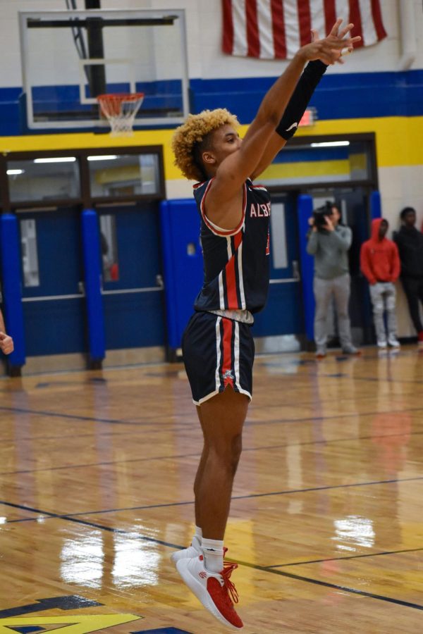 Senior Christian Humes takes a jump shot from the left corner of the court in the first few minutes of the 1/13 game.