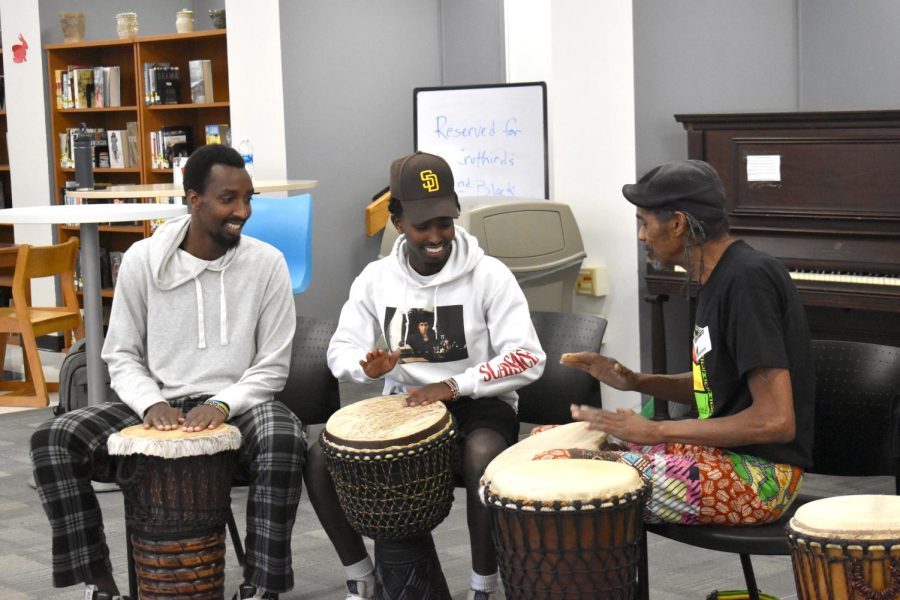 Senior Ebenezer Zikiel and junior Glorie Prince learn some rhythms from Chihamba drum circle leader William Whitten.  