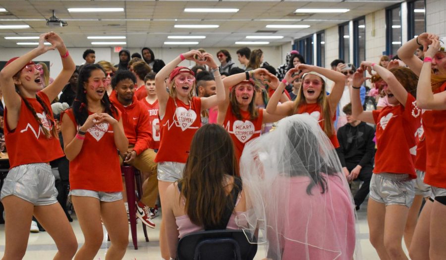Senior Heartstoppers hold up hand hearts for SCA members juniors Shea Hale and Maddie Gypson while singing Baby by Justin Bieber. Gypson was given a bridal veil to wear for the lunch competition proposal.