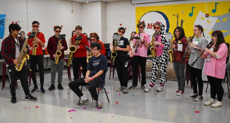 Dressed in a variety of costumes, Sax Choir members surround senior Tyler Heron during the lunchtime competition.