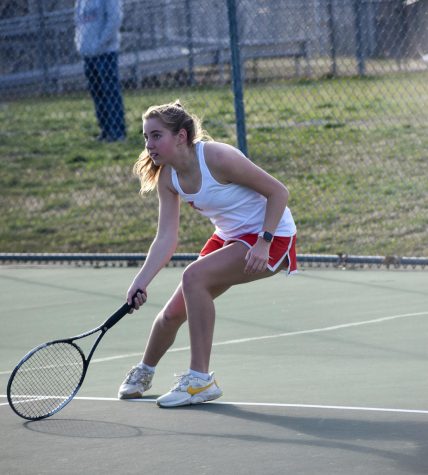 Lunging to her right, sophomore Macy Moody sets herself up to return the tennis ball to her opponent.