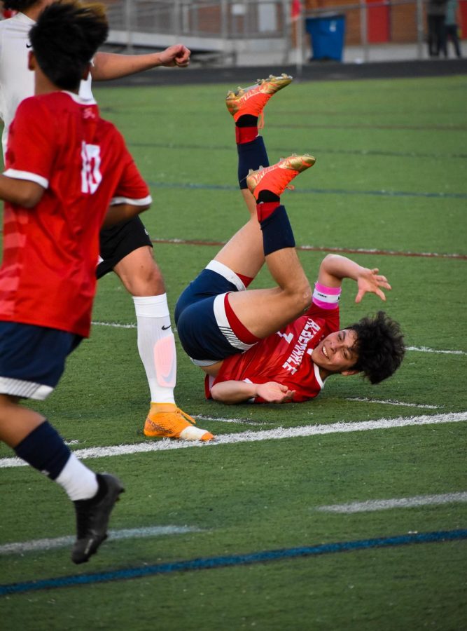 Senior captain Maycol Echeverria is tripped by a Monticello player as they fight for the ball.