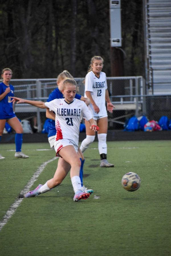 Sophomore Samantha Fischer drags her foot behind her while preparing to kick the ball up the field.