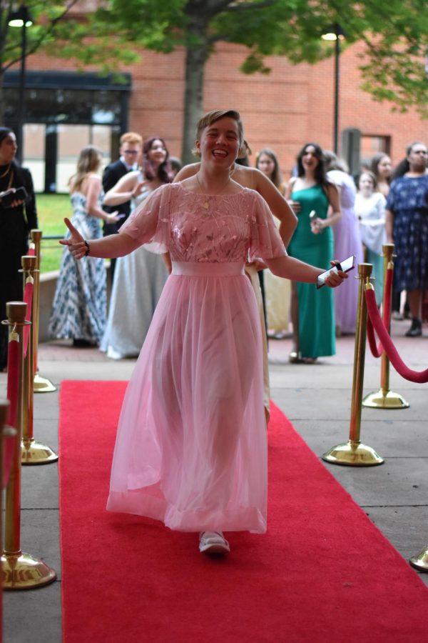 Junior Alexa Alms strolls down the red carpet in her pale pink gown.