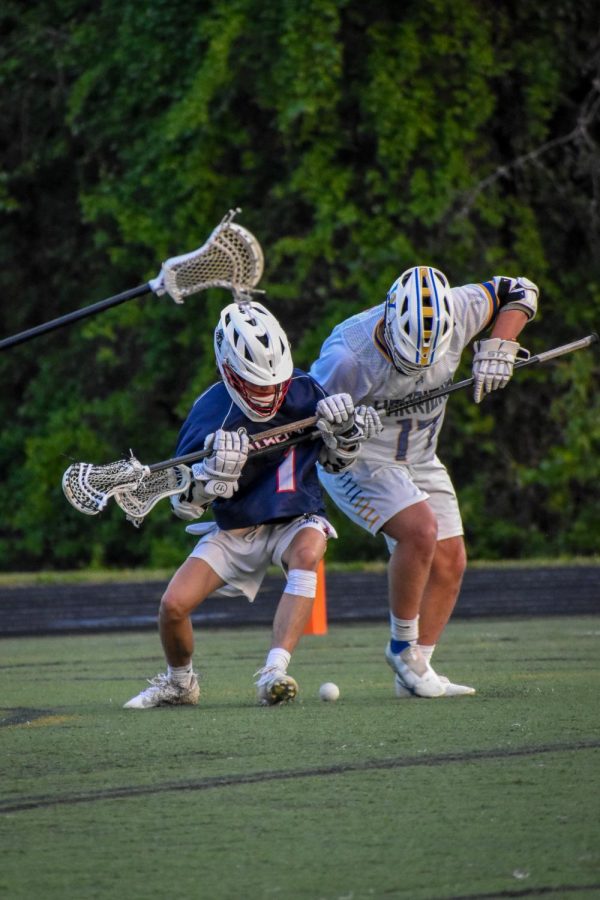 9th grade attacker Corbet Moyer boxes out Western defender Jake Fontaine before scooping the ground ball. 