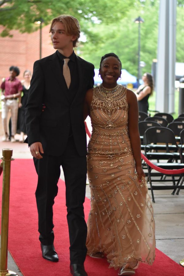 Seniors Mason Fischer and Destiny Edwards pair the elegant simplicity of black with a gold gown with jeweled overdress and matching make-up highlights.
