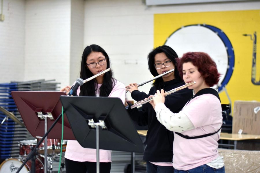 Senior Claire Engler (far right) plays the flute with juniors Crystal Jiang and Hazel Chen during the Tri-M coffeehouse on Feb. 28. 