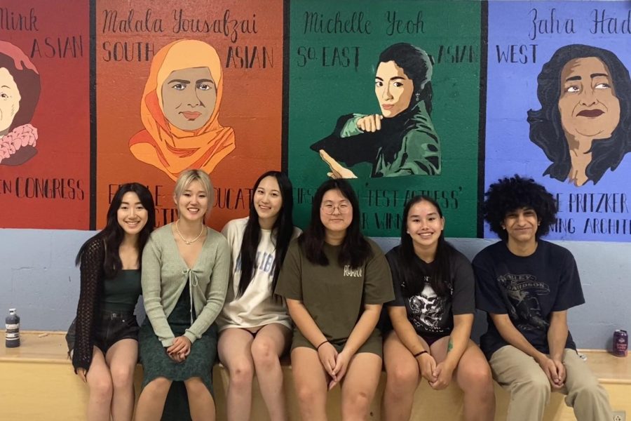 (Right to left) YAAPIC members juniors Anna Zheng, Helen Hou, Sophia Sun, Olivia Kim, Lizzie Frysinger and Sajad Alsafee (junior Bowen Dong and sophomore Isabelle Wang not pictured) smile in front of the finished mural. The team spent 22 hours planning, sketching and painting.