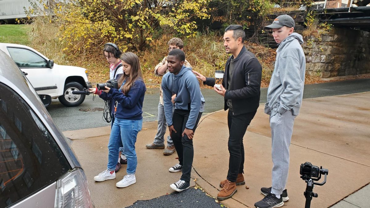 Mentor Han West gives advice before a shot to director senior Heba Alwan, writer senior Olivia Santiago, editor junior Brody Pleasants and production assistant sophomore Ace Swanson while actor Josh Mohale (AHS 23) waits to enter the scene. Filming took place over 72 hours from Nov. 8-11.