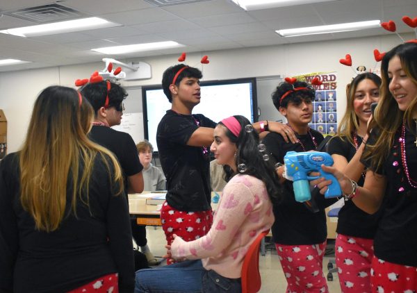 Members of 7 Corazones serenade junior Dena Mohammed Ali on Valentines Day as part of the annual V-Day Thing celebration. 