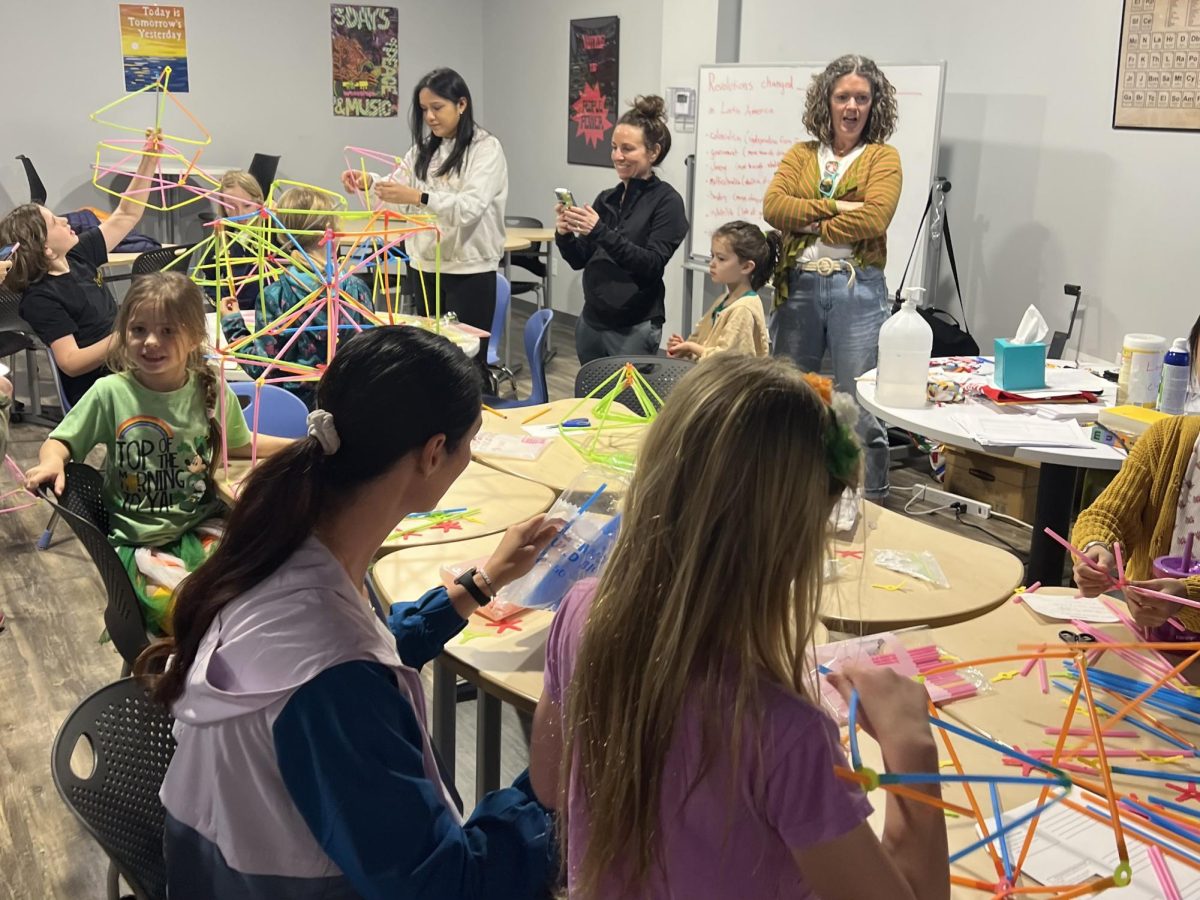 At Girls Geek Day, elementary-aged girls build structures using plastic tubes. SWE uses these projects like this to introduce girls to the basics of STEM.