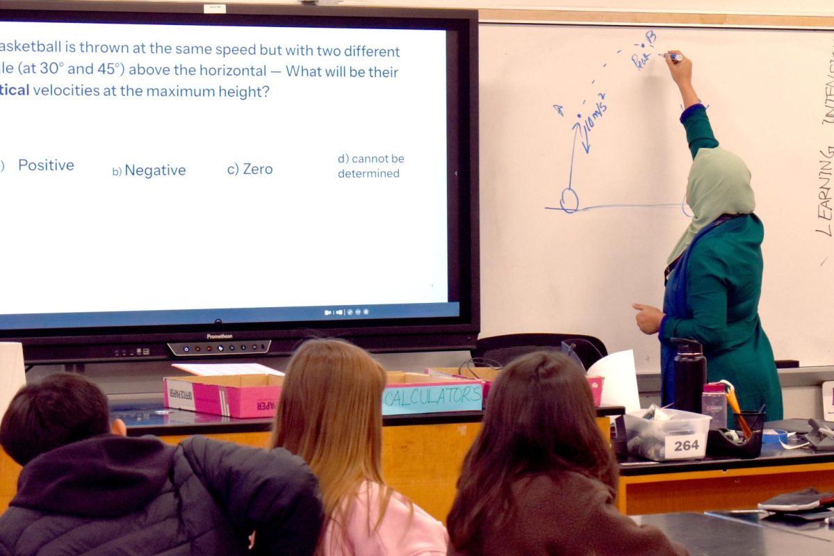 Physics teacher Asia Haque reviews projectile motion with her 3A scholars physics class. All 9th grades enrolled in a Scholars Studio were required to take the new physics course. 