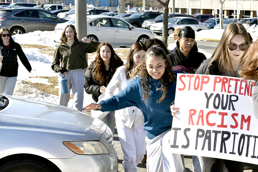 Students exit the parking lot to begin the walkout. Their route took them down Hydraulic Road to the Shops at Stonefield.