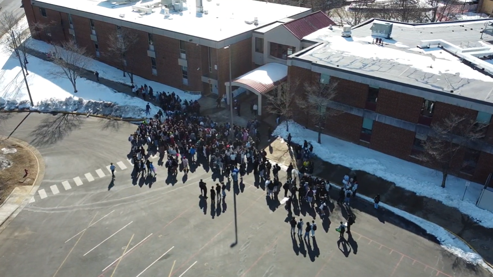 Students gather in the AHS bus lot before leaving campus.