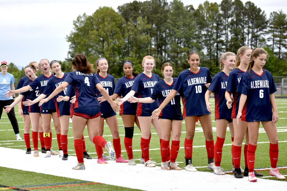 The 2025 girls varsity soccer team gets hyped up during their introduction.